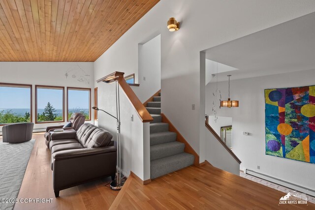 11411 Snowline Dr, Anchorage, AK 99507 - living area with a baseboard radiator, wood ceiling, wood finished floors, stairway, and a chandelier
