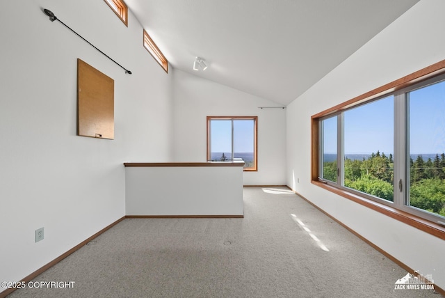 11411 Snowline Dr, Anchorage, AK 99507 - spare room featuring healthy amount of natural light, vaulted ceiling, and carpet