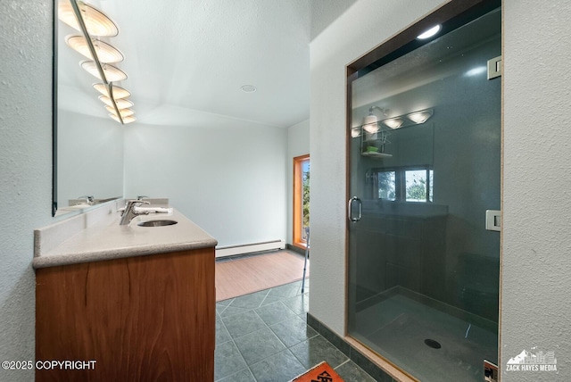 11411 Snowline Dr, Anchorage, AK 99507 - bathroom featuring a baseboard heating unit, tile patterned floors, vanity, and a stall shower