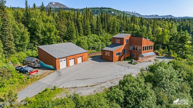 11411 Snowline Dr, Anchorage, AK 99507 - aerial view of property and surrounding area featuring a heavily wooded area and mountains