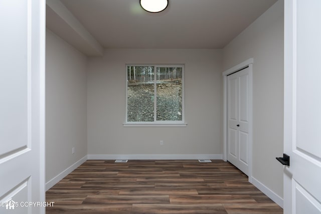 17939 Yellowstone Dr, Eagle River, AK 99577 - unfurnished bedroom with dark wood-style floors and a closet