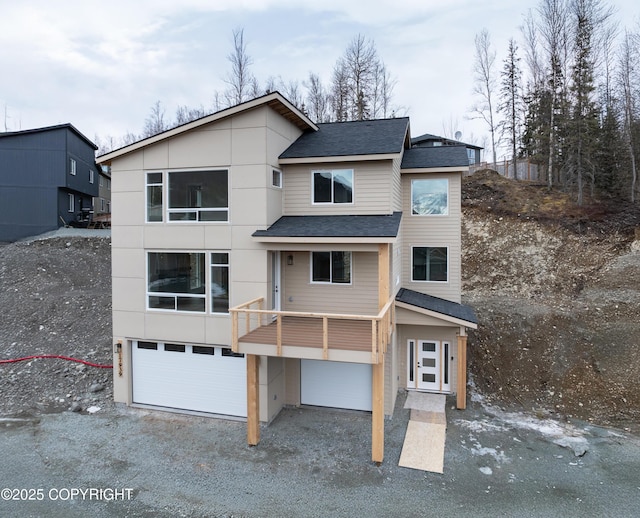 17939 Yellowstone Dr, Eagle River, AK 99577 - contemporary house featuring a garage, a shingled roof, and gravel driveway