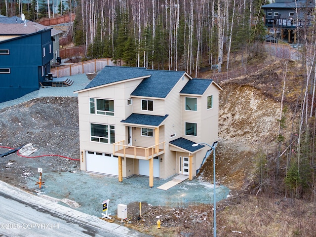 17939 Yellowstone Dr, Eagle River, AK 99577 - back of house with a shingled roof and an attached garage