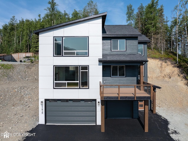 17939 Yellowstone Dr, Eagle River, AK 99577 - view of front of property with a garage, roof with shingles, asphalt driveway, and a balcony