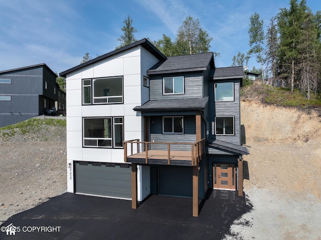 17939 Yellowstone Dr, Eagle River, AK 99577 - contemporary house with an attached garage, asphalt driveway, and a balcony