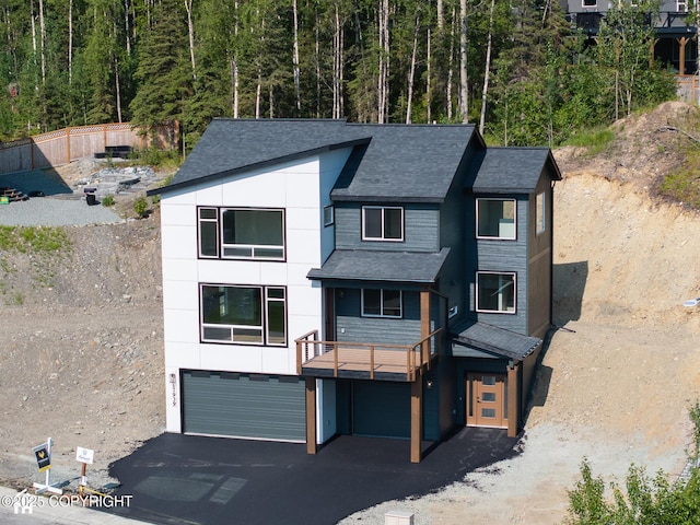 17939 Yellowstone Dr, Eagle River, AK 99577 - view of front of house featuring an attached garage, roof with shingles, and driveway