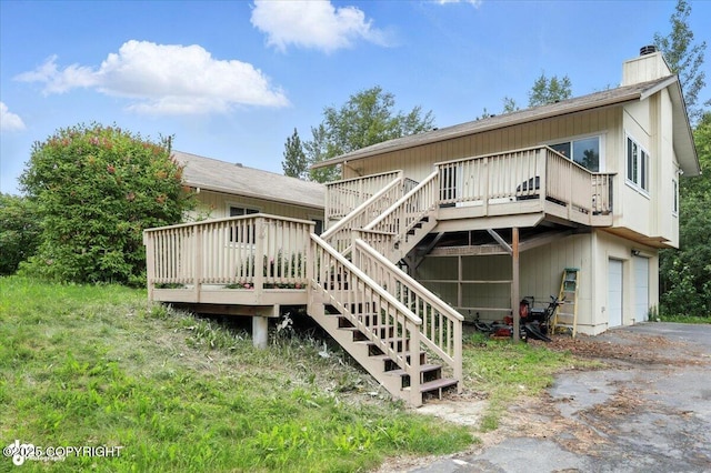 1447 N Ranch Rd, Palmer, AK 99645 - back of property with an attached garage, a wooden deck, a chimney, stairway, and driveway