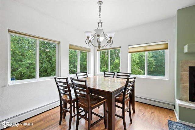 1447 N Ranch Rd, Palmer, AK 99645 - dining space featuring baseboard heating, a chandelier, and plenty of natural light