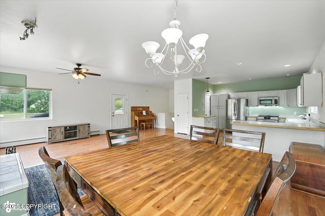 1447 N Ranch Rd, Palmer, AK 99645 - dining room featuring ceiling fan, a baseboard heating unit, a chandelier, recessed lighting, and light wood-style flooring