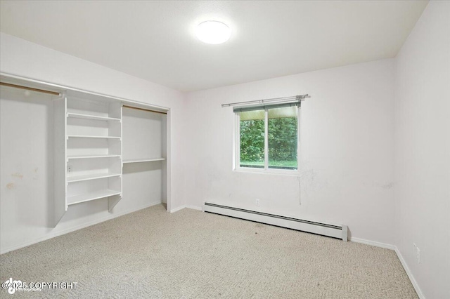 1447 N Ranch Rd, Palmer, AK 99645 - unfurnished bedroom featuring a baseboard heating unit, carpet, and a closet