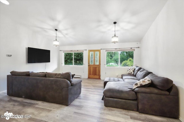 1447 N Ranch Rd, Palmer, AK 99645 - living area featuring healthy amount of natural light, wood finished floors, and a baseboard heating unit