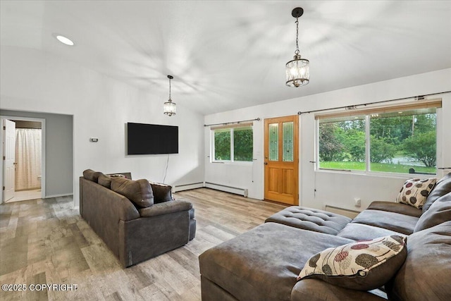 1447 N Ranch Rd, Palmer, AK 99645 - living area with lofted ceiling, light wood finished floors, a baseboard heating unit, and a baseboard radiator