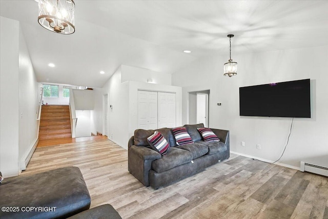 1447 N Ranch Rd, Palmer, AK 99645 - living area with lofted ceiling, wood finished floors, a chandelier, stairs, and baseboard heating