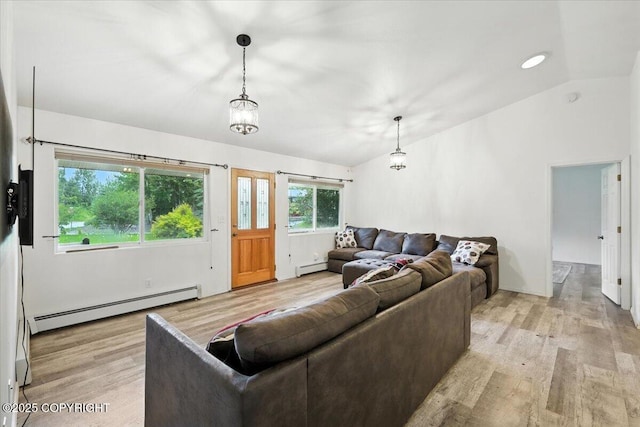1447 N Ranch Rd, Palmer, AK 99645 - living room featuring a baseboard heating unit, vaulted ceiling, light wood finished floors, and a baseboard radiator