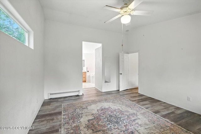 1447 N Ranch Rd, Palmer, AK 99645 - unfurnished bedroom featuring a baseboard heating unit, wood finished floors, ensuite bath, and a ceiling fan