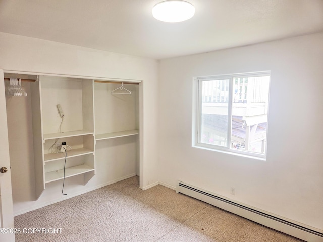 1447 N Ranch Rd, Palmer, AK 99645 - unfurnished bedroom featuring a baseboard radiator and a closet