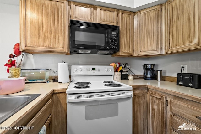 5320 Larkspur St, Anchorage, AK 99507 - kitchen featuring black microwave, white range with electric cooktop, and light countertops