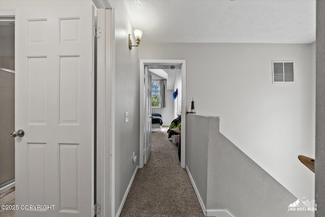 5320 Larkspur St, Anchorage, AK 99507 - hallway with an upstairs landing, carpet floors, and a textured ceiling