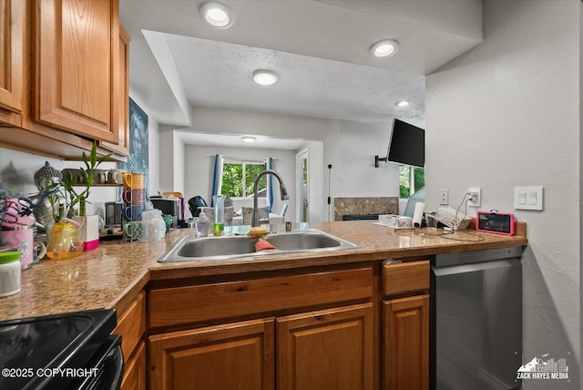 5320 Larkspur St, Anchorage, AK 99507 - kitchen with stainless steel dishwasher, brown cabinets, a peninsula, a textured ceiling, and light countertops