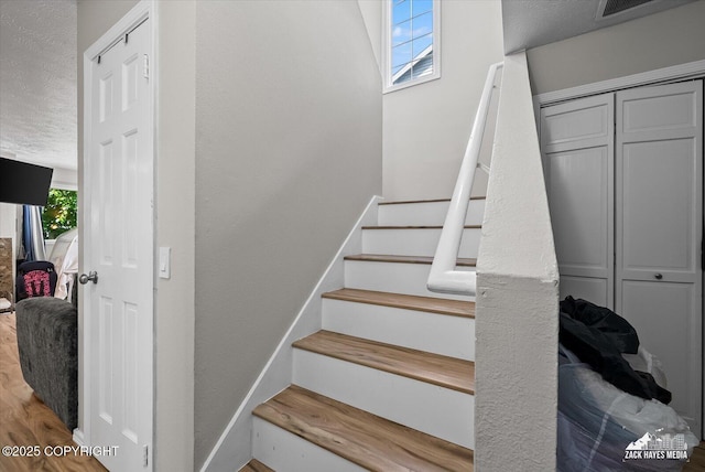 5320 Larkspur St, Anchorage, AK 99507 - staircase with a textured ceiling and wood finished floors