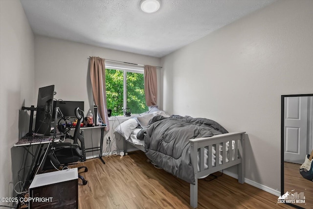 5320 Larkspur St, Anchorage, AK 99507 - bedroom featuring wood finished floors and a textured ceiling