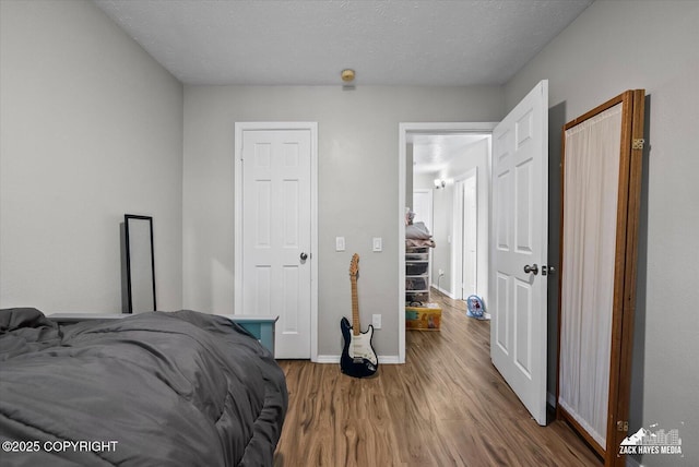 5320 Larkspur St, Anchorage, AK 99507 - bedroom featuring wood finished floors and a textured ceiling