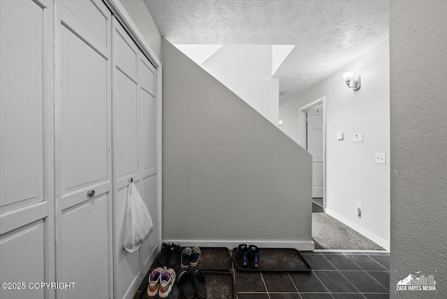 5320 Larkspur St, Anchorage, AK 99507 - stairway with a textured ceiling and tile patterned flooring