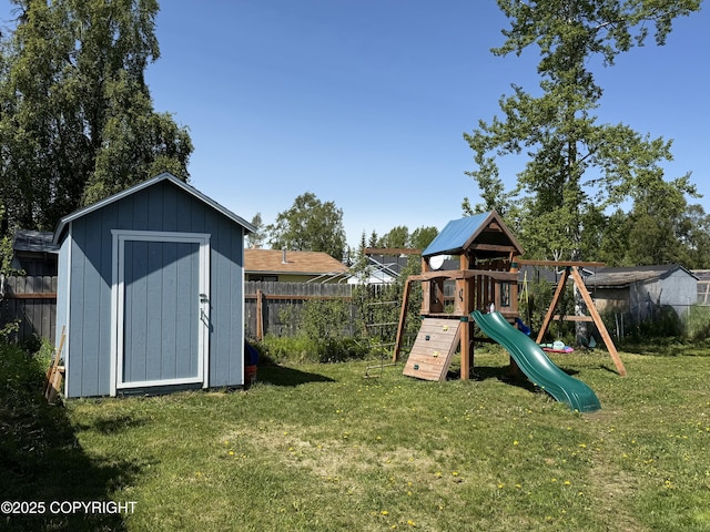 711 Maple Dr, Kenai, AK 99611 - view of playground featuring a storage unit and a fenced backyard