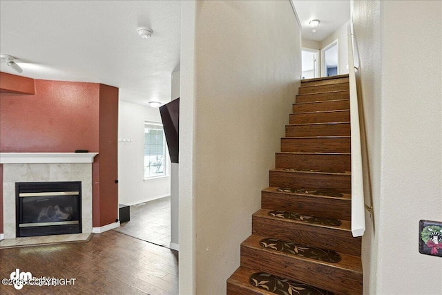 6403 E 10th Ave # 26, Anchorage, AK 99504 - stairs featuring wood finished floors and a tile fireplace