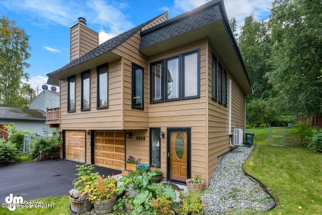 6340 Habicht Ct, Anchorage, AK 99504 - view of front of house featuring a chimney, asphalt driveway, an attached garage, and a shingled roof