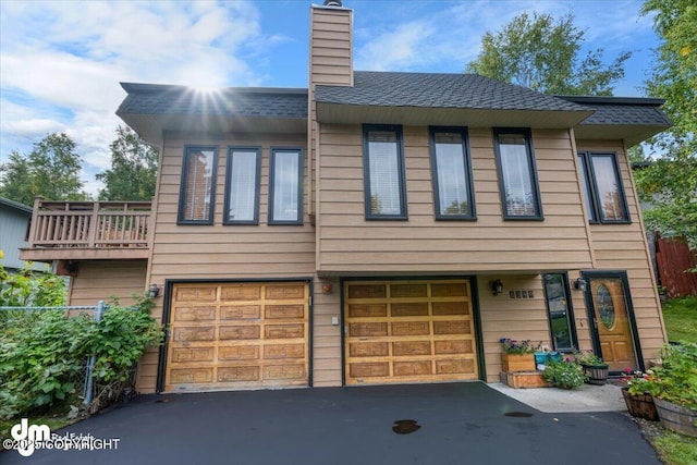 6340 Habicht Ct, Anchorage, AK 99504 - townhome / multi-family property with driveway, a garage, a chimney, and roof with shingles