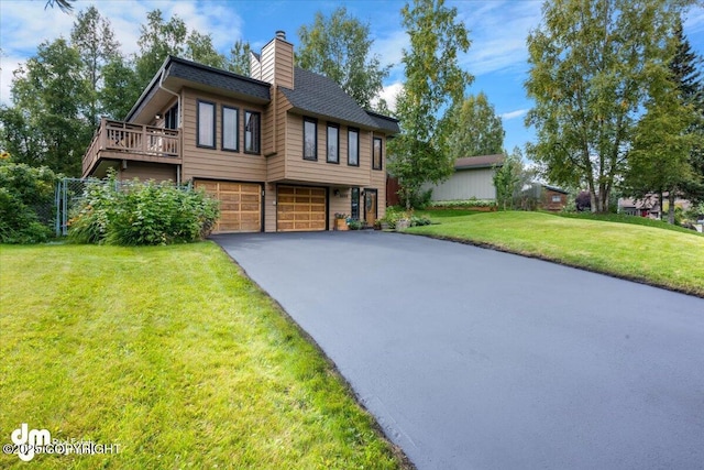 6340 Habicht Ct, Anchorage, AK 99504 - view of front of house featuring asphalt driveway, a garage, a chimney, and a front lawn