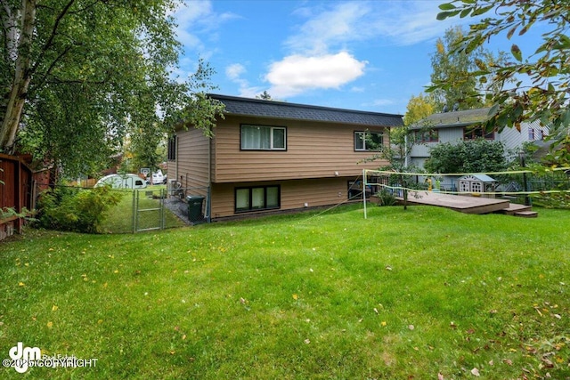 6340 Habicht Ct, Anchorage, AK 99504 - back of property with a fenced backyard, a gate, and a deck