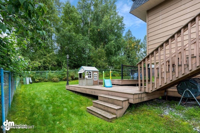 6340 Habicht Ct, Anchorage, AK 99504 - fenced backyard featuring a wooden deck, an outbuilding, and view of scattered trees