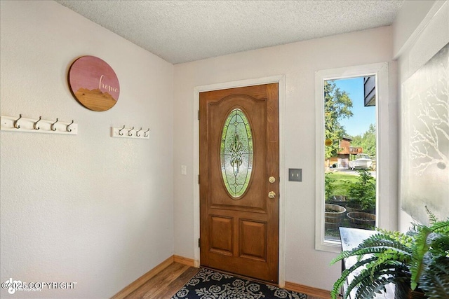 6340 Habicht Ct, Anchorage, AK 99504 - foyer entrance featuring wood finished floors and a textured ceiling