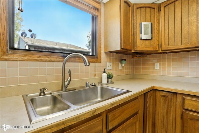 6340 Habicht Ct, Anchorage, AK 99504 - kitchen with brown cabinets, backsplash, light countertops, and plenty of natural light