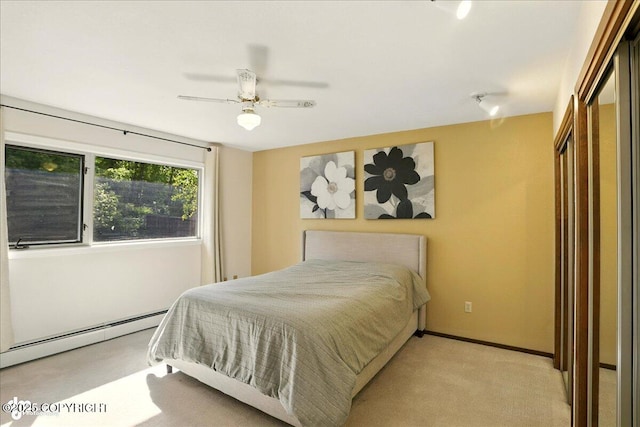6340 Habicht Ct, Anchorage, AK 99504 - bedroom with light colored carpet, baseboard heating, a closet, and a ceiling fan