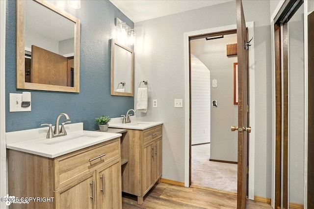 6340 Habicht Ct, Anchorage, AK 99504 - bathroom featuring wood finished floors, two vanities, and a textured wall