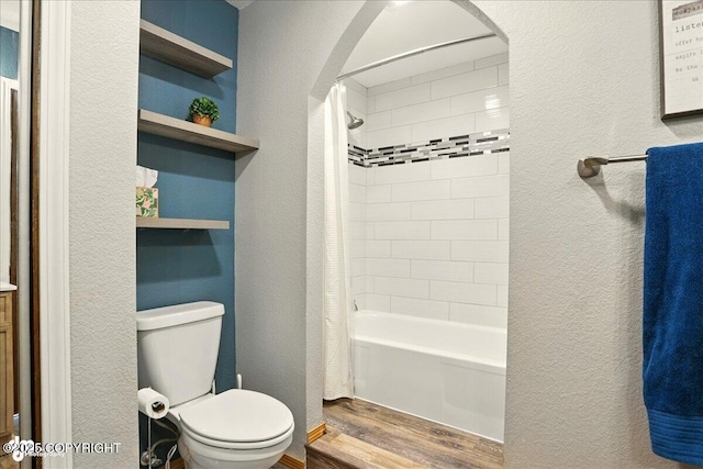 6340 Habicht Ct, Anchorage, AK 99504 - full bathroom featuring wood finished floors, a textured wall, and shower / tub combo with curtain