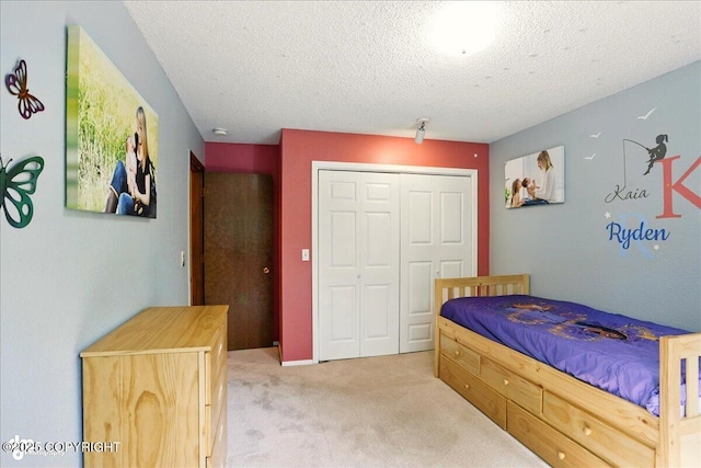 6340 Habicht Ct, Anchorage, AK 99504 - bedroom featuring light colored carpet, a closet, and a textured ceiling