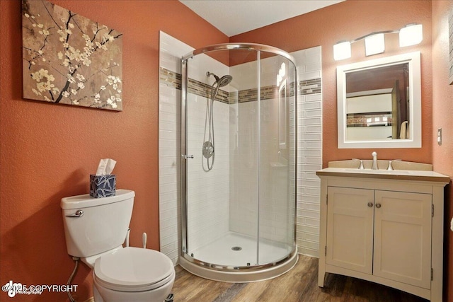 6340 Habicht Ct, Anchorage, AK 99504 - full bath featuring wood finished floors, a stall shower, vanity, and a textured wall