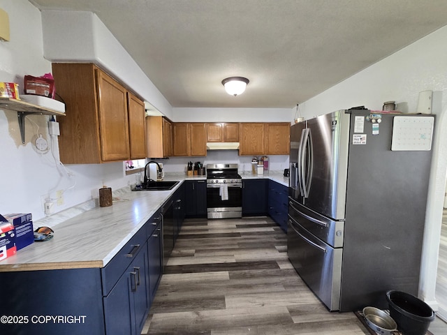 46270 Woodwill Dr, Kenai, AK 99611 - kitchen with stainless steel appliances, wood finished floors, light countertops, and under cabinet range hood