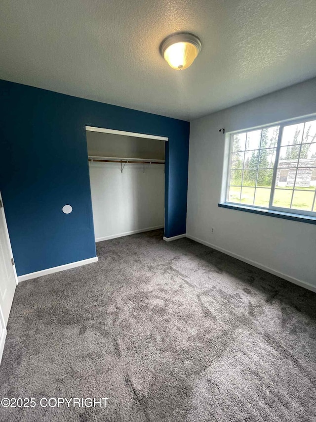 46270 Woodwill Dr, Kenai, AK 99611 - unfurnished bedroom featuring a textured ceiling, carpet flooring, and a closet