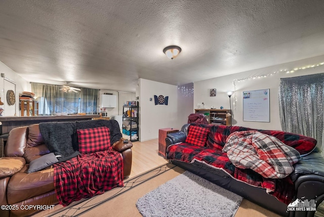 4116 W 88th Ave, Anchorage, AK 99502 - living room featuring a textured ceiling, wood finished floors, and a ceiling fan