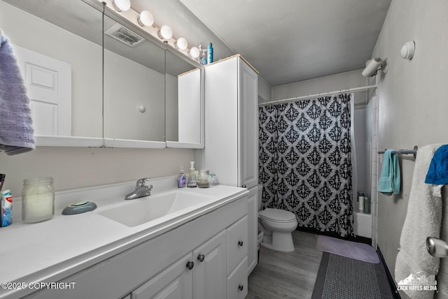 4116 W 88th Ave, Anchorage, AK 99502 - bathroom with vanity, shower / bath combination with curtain, and wood finished floors