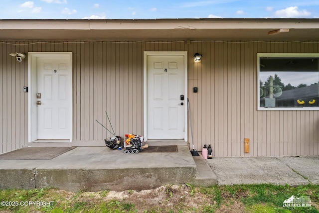 4116 W 88th Ave, Anchorage, AK 99502 - view of exterior entry with covered porch and a security system