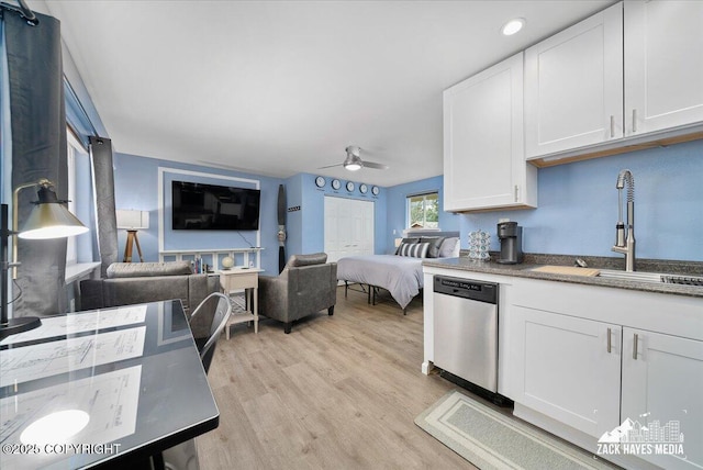 4116 W 88th Ave, Anchorage, AK 99502 - kitchen featuring stainless steel dishwasher, a ceiling fan, open floor plan, white cabinets, and light wood-type flooring