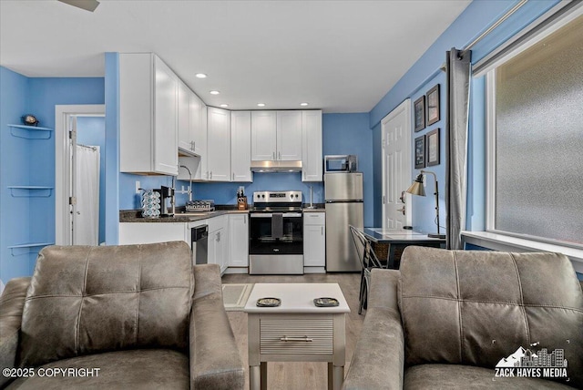 4116 W 88th Ave, Anchorage, AK 99502 - kitchen with stainless steel appliances, dark countertops, white cabinetry, and recessed lighting