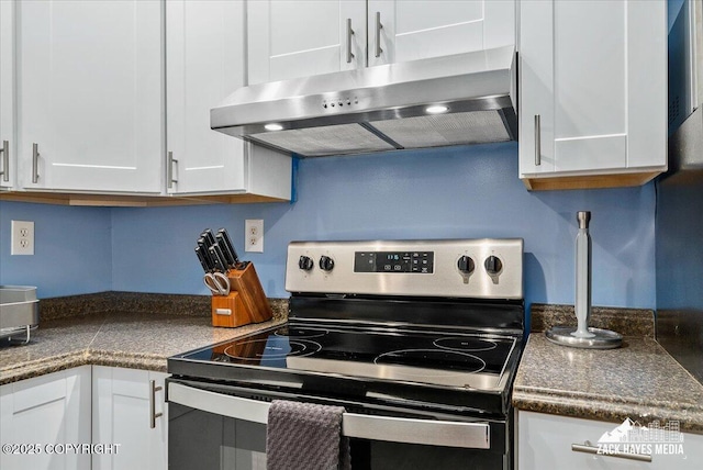 4116 W 88th Ave, Anchorage, AK 99502 - kitchen featuring stainless steel electric range, range hood, white cabinetry, and dark countertops