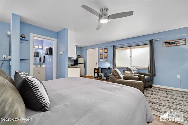 4116 W 88th Ave, Anchorage, AK 99502 - bedroom featuring freestanding refrigerator, connected bathroom, and a ceiling fan